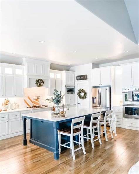 white kitchens with blue islands.